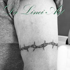 a woman's leg with barbed wire on it and the words la lunaia written in green ink