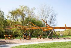 a wooden structure with people standing around it