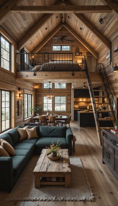 a living room filled with lots of furniture and wooden walls next to a stair case