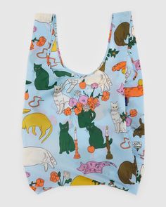 a blue bag with cats and flowers on it