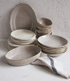 a stack of plates and bowls sitting next to each other