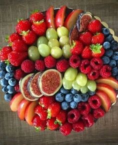 a platter filled with fruits and berries