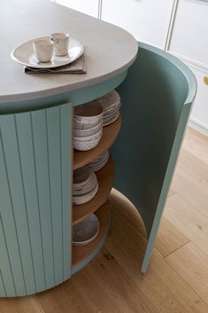 a kitchen island with plates and cups on it