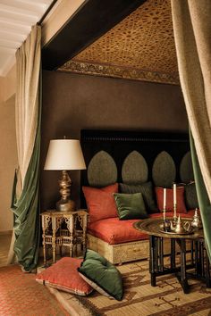 a living room filled with lots of furniture next to a wall covered in drapes