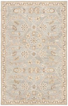 a gray and beige rug with an ornate design