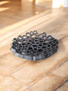 a metal object sitting on top of a tiled floor