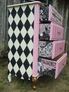 a pink and black checkered dresser with drawers