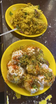 two yellow plates filled with different types of food