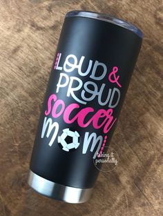 a black tumbler with pink and white lettering that says, loud & proud soccer mom