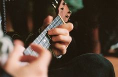 a person holding a guitar in their hands