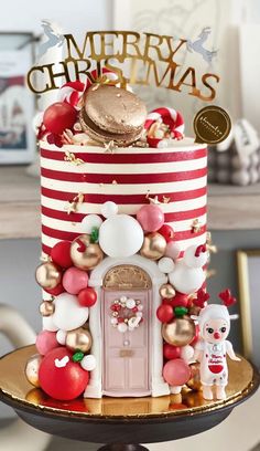 a red and white christmas cake with decorations on it's top, sitting on a table