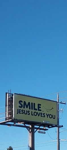 a billboard with the words smile jesus loves you on it