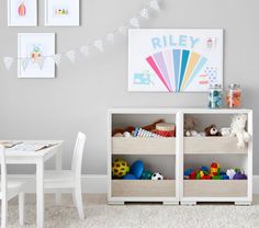 a white table and chairs in a room with pictures on the wall above it,