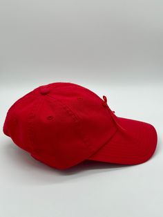 Red baseball cap featuring a red satin bow. Cap and ribbon are both vintage. Cap is unstructured and adjustable in size. Any idiosyncrasies, such as signs of wear or mending, are the result of the nature of the material’s long and rich history and should not be considered flaws or damage. Red Adjustable Baseball Cap With Curved Visor, Adjustable Red Baseball Cap With Curved Visor, Red Baseball Cap As Gift, Red Baseball Cap For Gift, Adjustable Red Dad Hat, Red Baseball Cap Gift, Classic Red Baseball Cap With Curved Brim, Adjustable Red Baseball Cap, Classic Red Hat With Curved Bill