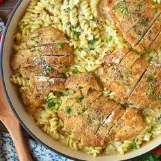 some meat and pasta in a skillet on a table