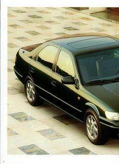 a black car is parked on the street