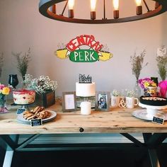 a wooden table topped with cakes and desserts