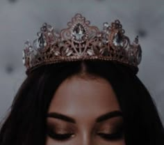 a close up of a woman wearing a tiara