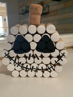 a bottle cap decoration made out of wine corks with a skull on it's head