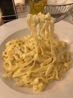 a white plate topped with pasta and cheese