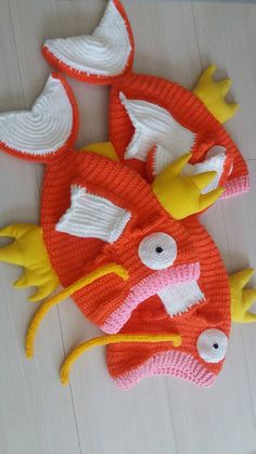 three knitted toys are laying on the floor