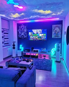 a living room filled with lots of furniture and colorful lights on the ceiling above it