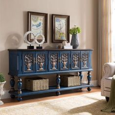 a living room with two pictures on the wall and a blue cabinet in front of it