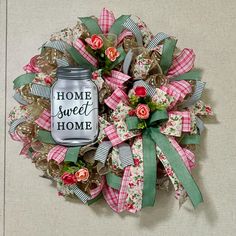 a wreath made out of fabric and ribbon with the words home sweet home on it