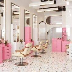 the interior of a salon with pink furniture and mirrors on the walls, along with white cabinets