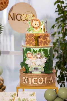 a three tiered cake decorated with jungle animals