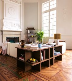 a living room filled with furniture and a fire place in the middle of a room