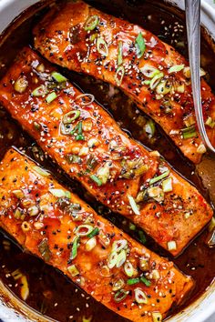 salmon with sesame seeds and seasoning in a pan