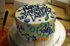 a white cake with blue and green designs on it