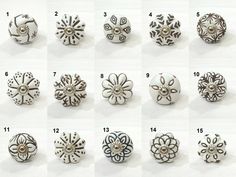 many different types of buttons with designs on them, all in various shapes and sizes