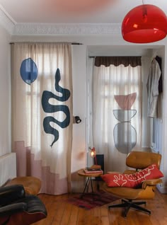 a living room filled with furniture and curtains