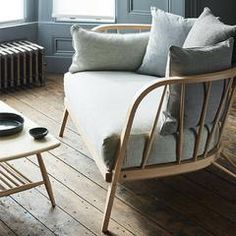 a living room filled with furniture next to a radiator and a heater