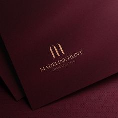 the logo for madeline hunt consulting, which is located on top of two sheets of paper