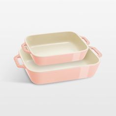 two pink dishes sitting on top of each other