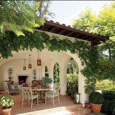 an outdoor dining area with potted plants and trees