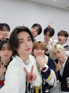 group of young men posing for the camera with their fingers up in front of them