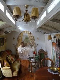 a living room filled with furniture next to a window covered in curtains and drapes