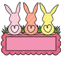 three bunnies sitting on top of a pink box with hearts in the grass behind them