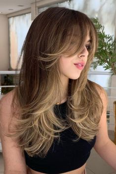 We’re rounding up 35 of the best summer hair trends for 2024 and our favorite professional products to help style them. Butterfly Haircut With Straight Bangs, Butterfly Haircut Dark Brown Hair, Half Up Half Down Wolf Cut, Brown Hair With Highlights And Bangs, Large Forehead Hairstyles, Butterfly Hairstyle, Summer Hair Trends, Haircuts For Long Hair With Layers, Chic Hairstyles