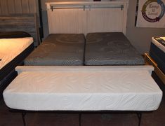 two mattresses sitting next to each other in a room