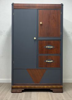 an armoire with two drawers on one side and a wooden door on the other