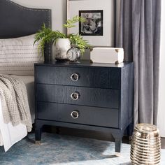 a bedroom scene with focus on the nightstand and bed side table in the foreground