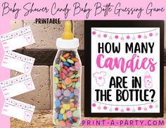 a bottle filled with candy next to a sign that says how many candies are in the bottle?