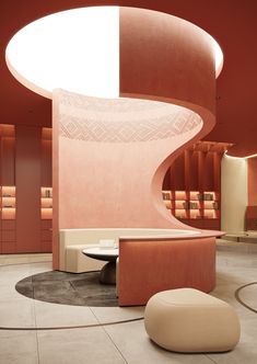 the interior of a modern salon with pink walls and circular seating area in front of it