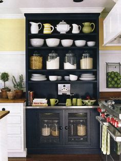 an open cabinet with pots and pans on it