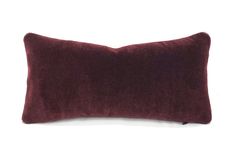 a dark red pillow on a white background